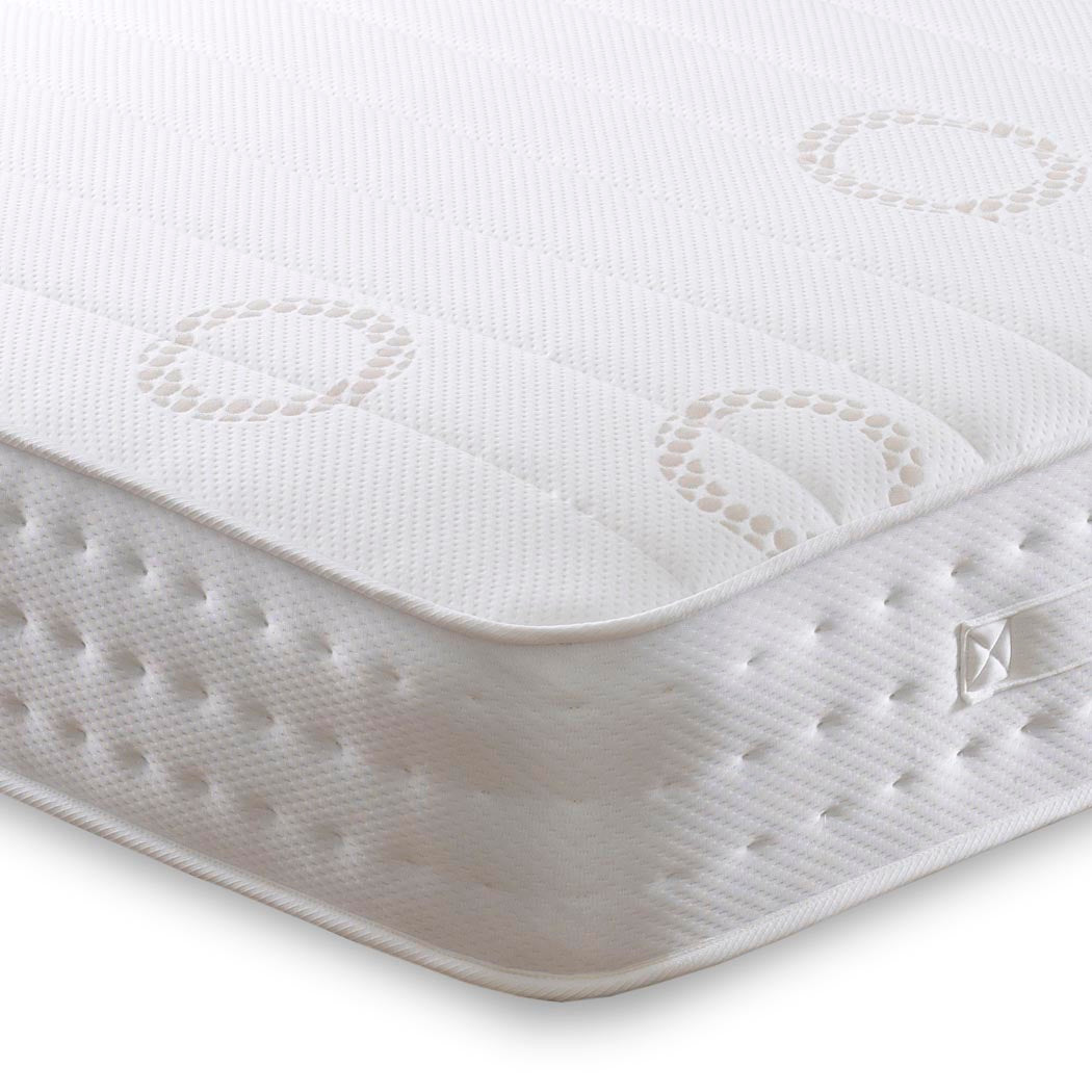 Close-up of a white mattress with textured surface and brand logo on a white background