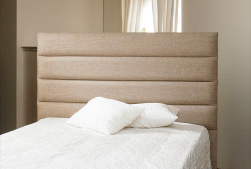 Rome floor standing upholstered in light cream fabric featuring a mattress with pillows 