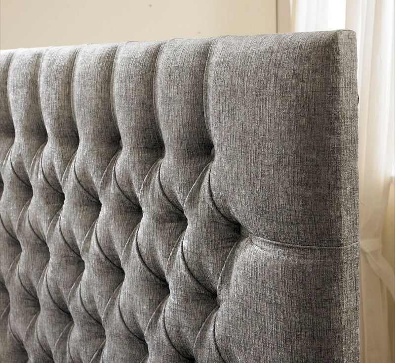 Close up of headboard upholstered in grey